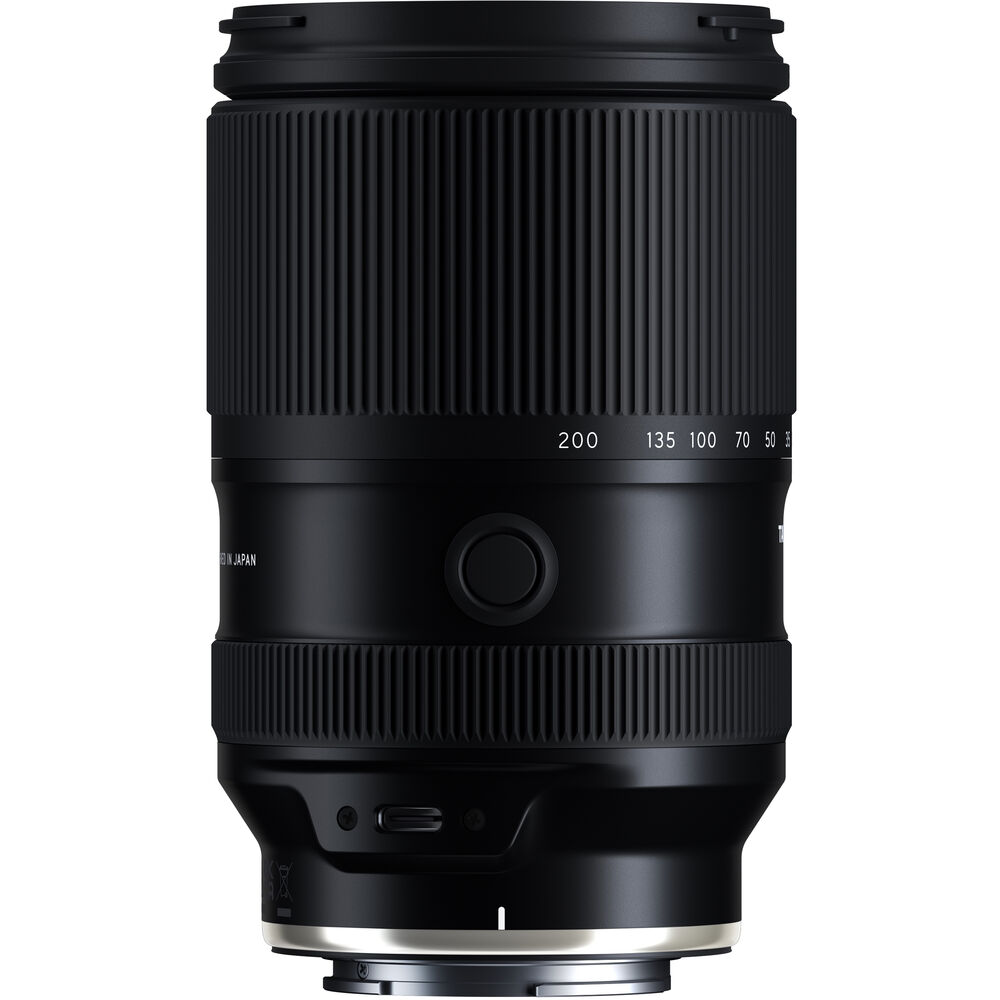 Black Tamron 25-200mm lens standing upright, front three-quarter view, on a white background