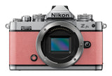 Nikon Z fc mirrorless camera in coral pink with Nikkor Z 28mm lens