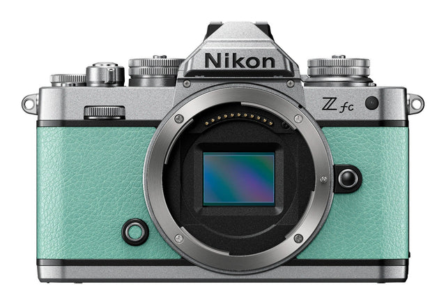 Nikon Z fc mirrorless camera in mint green with two zoom lenses