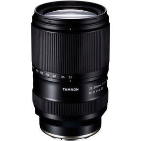 Black Tamron 25-200mm lens standing upright, front three-quarter view, on a white background