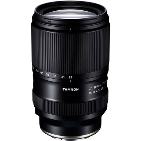 Black Tamron 25-200mm lens standing upright, front three-quarter view, on a white background