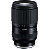 Black Tamron 25-200mm lens standing upright, front three-quarter view, on a white background