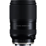 Black Tamron 25-200mm lens standing upright, front three-quarter view, on a white background