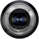 Black Tamron 25-200mm lens standing upright, front three-quarter view, on a white background